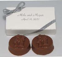 Bride and Groom Oreo Boxed - America&#8217;s favorite cookie is inserted in our "bride & groom" mold and covered in pure milk or dark chocolate.   The embossed "bride & groom" Oreo comes in a two-piece box and personalized with your choice of message.